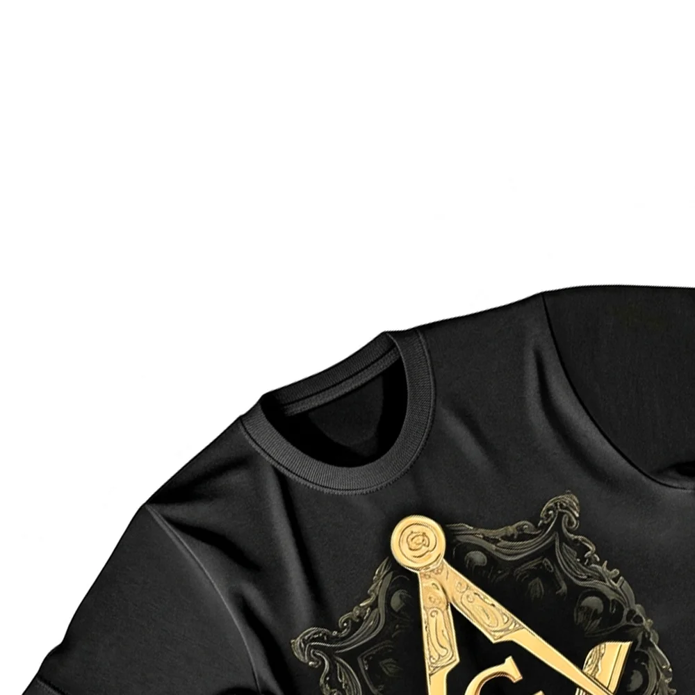 Close-up of the golden Square and Compass G symbol on a black Masonic graphic T-shirt.