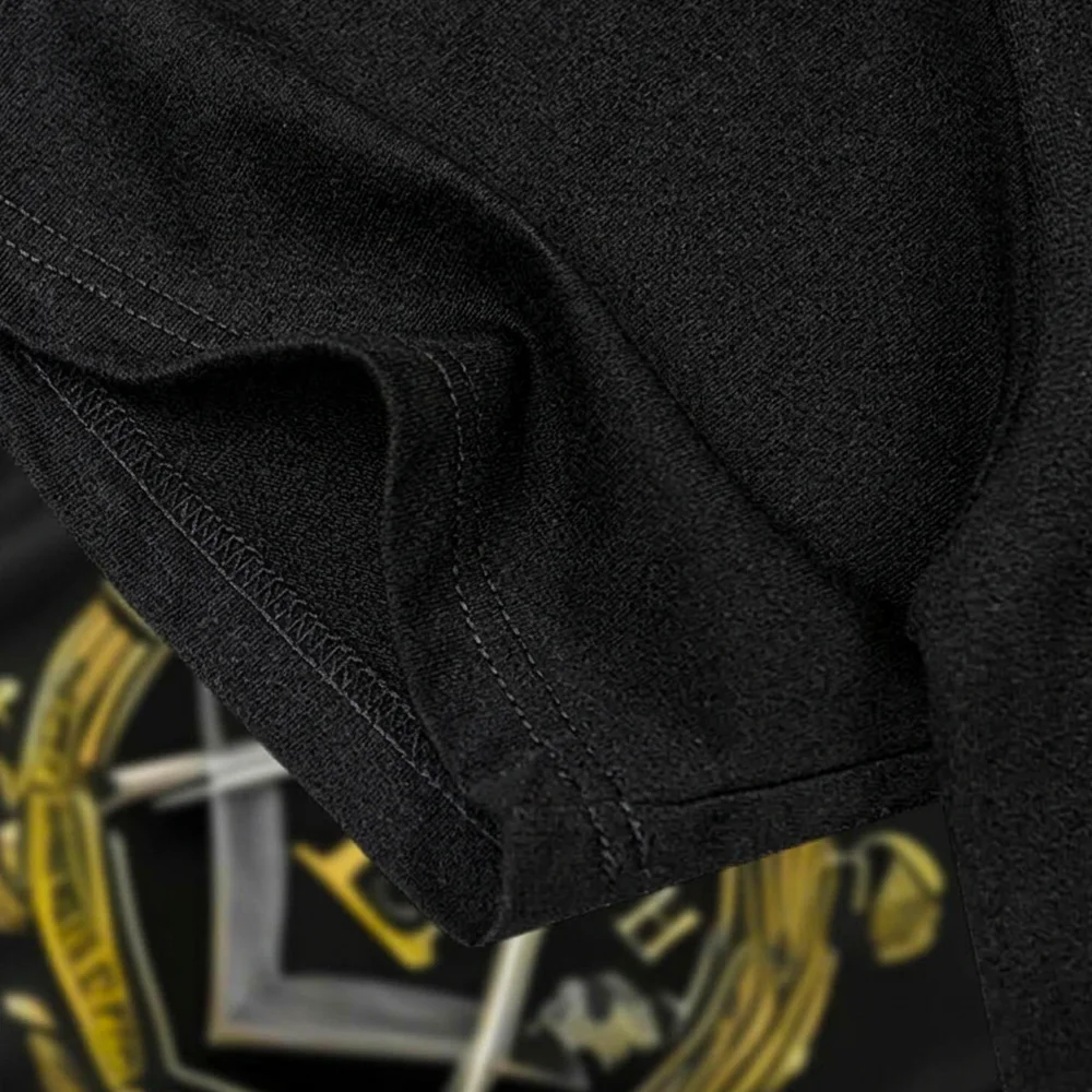 Masonic apparel featuring gold E lettering and a decorative Freemason symbol on a black shirt.