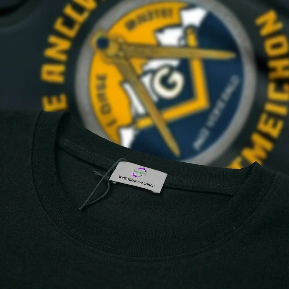 Artistic Masonic black T-shirt with blue mountain illustration and gold decorative symbolism.